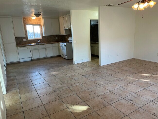 Open living room floor plan leading into kitchen area - 21625 Bear Valley Rd