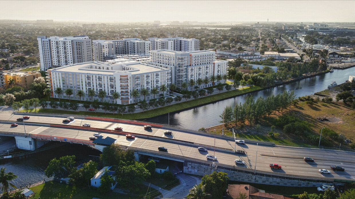 Elegant riverside apartment complex with modern architecture, lush greenery, and convenient location near a major highway, offering serene urban living. - Tides at River Rapids