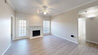 Located at 8359 Harwood Rd in North Richland Hills, TX, this single-story, 3-bedroom, 2-bathroom home offers a well-designed layout with a clean, neutral aesthetic throughout. Light gray laminate wood flooring runs consistently across the home, complemented by crisp white trim and warm beige walls.

The open-concept living, dining, and kitchen area serves as the heart of the home. The living room features crown molding, a ceiling fan, a tiled wood-burning fireplace, and a door providing access to the patio. The kitchen is equipped with white cabinetry, a stainless steel refrigerator, an electric range, a built-in microwave, and a peninsula breakfast bar with a light stone-style countertop — ideal for casual dining.

The primary bedroom is a comfortable retreat, and all three bedrooms feature ceiling fans and laminate flooring. Two bedrooms enjoy natural light through windowed blinds. Each of the two full bathrooms is finished in white, featuring tub-shower combinations, vanities with white cabinetry, and mirrors.

Additional highlights include four closets providing ample storage, a dedicated laundry area, an entrance hallway, and a patio for outdoor enjoyment. The home's cohesive, move-in-ready condition makes it a practical and inviting space.