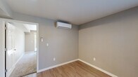 Located at 2401 Broadway St in Vallejo, California, this thoughtfully designed one-bedroom, one-bathroom unit offers a clean, modern aesthetic across a single floor. The living area features smooth light-toned luxury vinyl plank flooring, neutral gray walls, and a window that draws in natural light, creating a bright and welcoming atmosphere. A wall-mounted mini-split system ensures year-round climate comfort throughout the unit. The kitchen is efficiently laid out with crisp white shaker cabinetry, stone-look countertops, an undermount stainless steel sink, and a stainless steel dishwasher — combining style with practicality. The bedroom is a comfortable retreat, carpeted for warmth underfoot and featuring a sliding door to the outdoors, an additional window for cross-ventilation, a wall-mounted mini-split, and a spacious built-in closet with sliding doors. The bathroom is clean and functional, offering a vanity with storage drawers, a lighted mirror, and a walk-in glass-enclosed shower stall with wood-look flooring tying the space together. Neutral tones and consistent finishes throughout give the unit a cohesive, move-in-ready feel that is both practical and inviting.