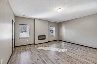 Large windows invite natural light, creating a bright and airy living space. - North Pointe Villas