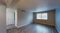 Located at 670 Prospect St in Berea, Ohio, this single-floor, one-bedroom, one-bathroom unit offers a practical and well-organized layout. The open combined living and dining area is finished with durable wood-look vinyl plank flooring and neutral gray walls, creating a clean, modern feel. A large window allows natural light to flow throughout the space, offering views of the surrounding neighborhood. The living area provides ample room for both relaxing and dining, with convenient access to additional rooms via a paneled interior door.

The kitchen is equipped with white appliances, including a refrigerator and range, set against wood-toned cabinetry — a functional setup for everyday cooking. The bedroom features plush carpeting, a ceiling fan with light fixture, and a window that continues the theme of natural light throughout the unit. Three closets provide generous storage solutions across the floor plan, complemented by a dedicated utility room.

The bathroom is a standout feature, showcasing a full tub and shower surround finished in large-format, marble-veined ceramic tile in soft neutral tones, paired with polished chrome fixtures for a clean, updated look. Throughout the unit, gray-toned walls, white trim, and consistent finishes contribute to a cohesive and move-in-ready aesthetic.