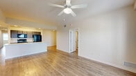 Located at 10 Betty Rose Drive in Key West, FL, this single-floor, 3-bedroom, 2-bathroom home offers a well-designed layout suited for comfortable living in a tropical setting. Light wood-style flooring runs throughout the entire home, creating a cohesive and airy aesthetic.

The open-concept kitchen and living area serves as the heart of the home. The kitchen features dark cabinetry, black appliances including a refrigerator, range, and microwave, and a spacious island with a light stone-finish countertop and an integrated sink — ideal for both cooking and casual dining. The living area is brightened by a ceiling fan and flows naturally from the kitchen space.

Each of the three bedrooms is outfitted with a ceiling fan and windows that allow natural light to pour in. The primary bedroom includes access to a private balcony. With seven closets spread throughout the home, storage is abundant. A dedicated laundry room with washer and dryer hookups and overhead wire shelving adds practicality.

Both bathrooms maintain a clean, modern look, with dark wood vanities, stone-finish countertops, and tub-shower combinations. A hallway connects the bedrooms and bathrooms, ensuring a functional and private layout. The overall ambiance is bright, clean, and move-in ready.