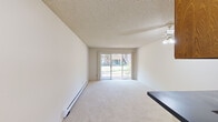 Located at 3670 Peacock Ct in Santa Clara, CA, this single-floor, one-bedroom, one-bathroom home offers a practical and well-organized layout. The combined kitchen and living area forms the heart of the space, with soft carpet underfoot in the living room and a ceiling fan overhead. Sliding glass doors open to an outdoor view of mature greenery, filling the room with natural light and creating a seamless indoor-outdoor connection. A baseboard heating system runs along the living room walls, ensuring comfort year-round. The kitchen is equipped with warm wood-toned cabinetry, a white electric range with overhead ventilation, a full-size refrigerator, and tile flooring, offering a functional cooking space. A hallway connects the main living areas to the private quarters. The spacious primary bedroom features plush carpet, a large window with outdoor views, and a sliding-door closet with built-in shelving and hanging rod for ample storage. The bathroom includes a vanity with cabinet storage, a framed mirror, skylight, and tile flooring, providing a clean and functional space. Textured ceilings throughout add a classic character to the home.