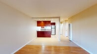 Located at 34500 Fremont Blvd in Fremont, California, this single-floor residence offers a thoughtfully designed layout that balances comfort and functionality. The open-concept living and dining area is anchored by warm hardwood flooring that flows throughout the main living spaces, creating a cohesive and inviting atmosphere. A large window in the living area frames outdoor greenery, filling the room with natural light.

The kitchen is a standout feature, showcasing rich cherry-toned cabinetry that extends to the ceiling, complemented by granite-style countertops and stainless steel appliances, including a full-size refrigerator. A peninsula counter visually connects the kitchen to the main living area, making it ideal for both cooking and entertaining. The kitchen interior offers ample storage with upper and lower cabinetry lining both walls, alongside a gas range and dishwasher.

An additional room features sliding glass doors that open directly to a private outdoor patio, providing easy indoor-outdoor access and a pleasant view of the enclosed exterior space. The bathroom is clean and functional, featuring a tub and shower combination with a sliding glass door, a granite-topped vanity with cherry wood cabinetry, and a bright window above the tub for natural ventilation. Light tile flooring completes the bathroom's crisp, practical design.