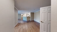 Located at 2525 Crescent Cove Dr in Evans, Colorado, this well-appointed single-story home offers five bedrooms and two full bathrooms with a thoughtfully designed layout. The open-concept kitchen and living area serves as the heart of the home, featuring warm wood-look flooring, crown molding, and a ceiling fan with light fixture. The kitchen is outfitted with crisp white cabinetry, granite-look countertops, stainless steel appliances including a dishwasher and refrigerator, and a functional breakfast bar peninsula. A dedicated pantry closet provides generous storage. The living room offers sliding glass door access and abundant natural light. Each bedroom features neutral warm-toned walls, wood-look flooring, and windows with horizontal blinds that allow for natural light. The primary bedroom provides a comfortable and versatile space. Both bathrooms are finished consistently with white vanity cabinetry, granite-look countertops, large mirrors, and modern lighting fixtures. One bathroom includes a soaking tub with shower, while the other features a walk-in shower. The home's cohesive neutral palette and durable flooring throughout create a clean, move-in ready environment suited for a variety of lifestyles.