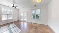Located at 300 S Skyloft Dr in Asheville, NC, this one-bedroom, one-bathroom unit offers a well-designed layout with distinct character throughout. Polished concrete floors run continuously across the entire space, providing an industrial yet refined aesthetic that ties each room together.

The entryway hallway immediately showcases one of the unit's standout design elements — a striking exposed brick accent wall that extends into the open living and kitchen area. The kitchen is outfitted with rich wood cabinetry, granite countertops, a stainless steel refrigerator, a microwave, and a double-basin sink, offering both style and function.

The living room is bright and welcoming, featuring French doors and multiple windows that invite generous natural light and outdoor views. A ceiling fan adds comfort and circulation to the space.

The bedroom continues the design language of the home with a horizontal wood plank accent wall, large windows, and a ceiling fan. A dedicated closet and stacked in-unit washer/dryer provide practical convenience.

The bathroom is clean and modern, featuring large-format tile walls in the walk-in shower, a decorative pebble stone shower floor, brushed nickel fixtures, and grab bars for added accessibility. A window allows natural light to brighten the space.