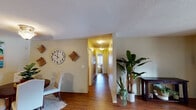 Located at 715 Ash in the Fontana community of San Marcos, this single-story unit offers a well-organized layout designed for comfortable everyday living. Wood-style flooring runs throughout the main areas, creating a warm and cohesive look that connects the living, dining, and kitchen spaces.

The living room is a bright, inviting space anchored by a sliding glass door that opens to a private patio, allowing natural light to fill the room. Adjacent to the living area, a dedicated dining nook provides an intimate space for meals, accented by a pendant light overhead.

The galley-style kitchen is efficiently designed with warm wood cabinetry, granite-look countertops, and a full suite of white appliances including a refrigerator, electric range, built-in microwave, and dishwasher. A hallway connects the main living areas to the bedrooms, each offering wood-style or carpeted flooring and generous closet space, including sliding double-door closets for ample storage.

The bathrooms feature granite-look vanity countertops, warm wood cabinetry, and tub/shower combinations. The primary bedroom includes an en-suite bathroom for added privacy. Throughout the unit, neutral wall tones and textured ceilings provide a clean, understated backdrop.