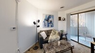 Located at 202 E John St in Champaign, Illinois, this 2-bedroom, 1-bathroom unit offers an efficient and well-organized single-floor layout. A carpeted hallway connects the main living spaces, creating a cohesive flow throughout. The living room is bright and welcoming, featuring carpet flooring, white walls, and a sliding glass door that opens directly onto a private balcony — bringing in natural light and an outdoor connection. The kitchen is clean and functional, outfitted with white cabinetry, white appliances, and wood-look flooring. Adjacent to the kitchen is a utility room equipped with overhead cabinets, a utility sink, and countertop space — a practical bonus for everyday living. The two bedrooms are carpeted and finished with neutral white walls, offering quiet, restful spaces. The primary bedroom accommodates a full-size bed comfortably and includes a closet, while the second bedroom is cozy and similarly appointed. The shared bathroom features wood-look flooring, a walk-in shower with a curtain, a toilet, and a single-sink vanity with white cabinetry. Two closets throughout the unit provide convenient storage. The overall ambiance is clean, minimal, and functional — well-suited for student or professional living near the University of Illinois Urbana-Champaign campus.