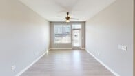 Located at 2120 N Brevard St in Charlotte, NC, this well-appointed apartment offers four bedrooms and three bathrooms across a single thoughtfully designed floor. The open-concept kitchen and living area serves as the heart of the home, showcasing dark cabinetry, granite countertops, stainless steel appliances, a tile backsplash, and light hardwood-style flooring. Pendant lighting adds a modern touch, while a door from the living room leads to a private balcony overlooking a landscaped greenway and the surrounding Charlotte skyline—an ideal spot to enjoy the outdoors. The bedrooms feature plush carpeting, ceiling fans, and large windows that bring in generous natural light and urban views. The primary bedroom includes a dedicated walk-in closet with wire shelving for ample organization. The bathrooms are finished with granite vanities, dark cabinetry, and subway tile surrounds in the tub/shower combinations. A dedicated laundry room with washer, granite-topped cabinetry, and open shelving adds functional convenience. Neutral gray tones throughout the unit create a clean, contemporary ambiance that complements the modern finishes at every turn.