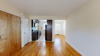 Located at 210 W Crystal Lake Ave in Haddonfield, NJ, this single-floor residence offers a well-designed layout with a clean, neutral aesthetic throughout. Warm hardwood flooring flows seamlessly across the living, dining, and bedroom areas, creating a cohesive and inviting atmosphere.

The open living area is bright and spacious, with white walls, textured ceilings, and ample room for a variety of furniture arrangements. It connects naturally to a dedicated dining space, highlighted by a pendant light fixture and views of the outdoors. The kitchen is efficiently laid out with dark cabinetry, granite countertops, black appliances including a gas range and refrigerator, and light tile flooring — all illuminated by a window that brings in natural light.

The bedrooms are generously sized, each featuring hardwood floors and windows with views of surrounding greenery. One bedroom includes a ceiling fan and a closet, while another offers direct access to a full bathroom, providing added convenience. The bathroom is tastefully renovated, showcasing tile surround walls with a decorative mosaic accent, a soaking tub with a sliding glass enclosure, and a wood-toned vanity with a white countertop. Radiator heating units are present throughout, ensuring consistent comfort year-round.