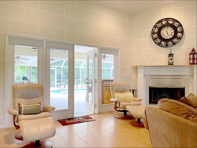 open living room with pool view - 17087 133rd Trl N