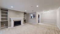 Located at 100 Calibre Brooke Way in Smyrna, GA, this one-bedroom, one-bathroom unit offers a well-designed single-level layout with a comfortable and functional living experience. The living room serves as the centerpiece of the home, highlighted by a classic fireplace framed by a white mantel with built-in shelving on either side — an ideal feature for both storage and display. Crown molding accents the ceiling, and plush neutral-toned carpet flows throughout the main living areas, adding warmth underfoot. Recessed lighting and ceiling fans are found throughout, ensuring a well-lit and comfortable environment year-round. The kitchen features rich dark cabinetry, light stone countertops, stainless steel appliances including a gas range, microwave, and refrigerator, and durable hardwood-style flooring. The bedroom is generously sized, bathed in natural light through a large triple window, and includes a ceiling fan. A sliding glass door opens to a private outdoor deck overlooking greenery, offering a peaceful retreat. The full bathroom includes a tiled tub-shower combination with chrome fixtures. A utility room and three closets provide ample storage throughout this thoughtfully laid-out Smyrna residence.
