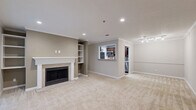 Located at 100 Calibre Brooke Way in Smyrna, GA, this one-bedroom, one-bathroom unit offers a well-designed single-level layout with a comfortable and functional living experience. The living room serves as the centerpiece of the home, highlighted by a classic fireplace framed by a white mantel with built-in shelving on either side — an ideal feature for both storage and display. Crown molding accents the ceiling, and plush neutral-toned carpet flows throughout the main living areas, adding warmth underfoot. Recessed lighting and ceiling fans are found throughout, ensuring a well-lit and comfortable environment year-round. The kitchen features rich dark cabinetry, light stone countertops, stainless steel appliances including a gas range, microwave, and refrigerator, and durable hardwood-style flooring. The bedroom is generously sized, bathed in natural light through a large triple window, and includes a ceiling fan. A sliding glass door opens to a private outdoor deck overlooking greenery, offering a peaceful retreat. The full bathroom includes a tiled tub-shower combination with chrome fixtures. A utility room and three closets provide ample storage throughout this thoughtfully laid-out Smyrna residence.