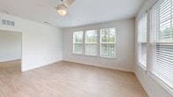 Located at 5151 Patriarch Place in North Augusta, SC, this well-appointed 2-bedroom, 2-bathroom single-floor home offers a clean, modern aesthetic with bright, open interiors throughout. Light wood-style flooring flows consistently across the living spaces, complementing the crisp white walls and creating a warm, contemporary feel.

The open-concept kitchen and living area serves as the heart of the home, featuring a central island with a white quartz countertop, white shaker cabinetry, subway tile backsplash, stainless steel appliances including a refrigerator and microwave, and stylish pendant lighting. A glass-paned door provides access to the outdoors and fills the space with natural light.

Both bedrooms are generously proportioned, each offering ceiling fans, large windows with views of surrounding greenery, and ample natural light. The primary bedroom connects to a spacious en-suite bathroom with a walk-in glass-enclosed shower, a double-sink vanity with white cabinetry, and matte black hardware accents. The second bathroom features a tiled tub-shower combination with matching matte black fixtures.

Additional highlights include a dedicated laundry room with full-size washer and dryer, two closets for storage, and a hallway connecting the private quarters. The overall ambiance is fresh, functional, and move-in ready.