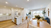 Located in San Diego, CA 92122, Unit 307 is a thoughtfully designed 2-bedroom, 3-bathroom residence that combines modern finishes with a bright, airy aesthetic throughout. Light wood flooring runs seamlessly across all rooms, complementing the clean white walls and creating a cohesive, contemporary feel.

The kitchen is a standout feature, boasting white shaker cabinetry extending to the ceiling, quartz countertops, stainless steel appliances, and a geometric tile backsplash with under-cabinet lighting. An island provides additional prep and storage space.

The living room is open and inviting, with recessed lighting and a sliding glass door that opens to a private balcony, offering pleasant outdoor views of the surrounding San Diego neighborhood.

The primary bedroom is generously sized, featuring its own sliding door to the balcony and a walk-in closet with multi-tier shelving. The additional bedroom includes a built-in closet and a bright window with neighborhood views.

All three bathrooms are finished with white vanity cabinetry, quartz countertops, and framed mirrors, maintaining a clean, consistent design language. A dedicated hallway connects the rooms efficiently, and the overall layout maximizes the comfortable square footage available in this well-appointed San Diego residence.