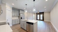 Located at 200 W Edge Way in Lynchburg, Virginia, this well-appointed single-story, 3-bedroom, 2-bathroom home offers a thoughtfully designed layout with modern finishes throughout. The open-concept kitchen and living area serves as the heart of the home, featuring gray shaker-style cabinetry, a white quartz countertop island with an undermount sink, stainless steel appliances, a subway tile backsplash, and elegant pendant lighting. Light wood-look flooring flows through this space, complemented by crown molding and recessed lighting. The living area opens to the outdoors through dark-framed glass doors, inviting natural light and outdoor views. The bedrooms are carpeted for comfort, each equipped with ceiling fans and windows that bring in natural light. The spacious primary bedroom includes access to a walk-in closet. Both bathrooms are finished with gray shaker vanities, white quartz countertops, and large-format tile flooring laid in a diagonal pattern. The dedicated laundry room features matching tile flooring and ample space for full-size appliances. With five closets and a pantry, storage is plentiful throughout this well-organized and move-in-ready home.