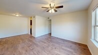 Located at 419 Bradleyville Rd in North Augusta, SC, this single-floor, two-bedroom, one-bathroom home offers a practical and comfortable layout. Throughout the living areas and bedrooms, wood-style flooring adds warmth and visual continuity, while textured ceilings lend a classic residential feel.

The living room is a generously sized open space featuring a ceiling fan with light fixture and windows that invite abundant natural light and outdoor views of the surrounding greenery. The layout connects seamlessly to the galley-style kitchen, which is well-appointed with dark espresso cabinetry, granite-look countertops, a double-basin sink, and white appliances including an electric range and refrigerator.

The spacious primary bedroom features dual closets, a ceiling fan, and direct access to the full bathroom, which is finished with tile flooring, a dark-toned vanity with a white countertop, and a tiled shower. The second bedroom is well-proportioned with a window offering outdoor views and matching wood-style flooring.

A dedicated laundry area with hookups provides added convenience, while a hallway with a closet offers additional storage. Neutral wall tones throughout create a clean, move-in-ready environment suited to a variety of personal styles.