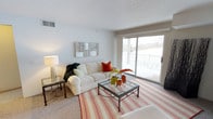 This well-appointed 2-bedroom, 2-bathroom residence is thoughtfully laid out across a single floor, offering a comfortable and functional living experience. The living room serves as the centerpiece of the home, featuring plush carpeting, neutral wall tones, and a sliding glass door that floods the space with natural light and opens directly onto a private balcony with outdoor views — an ideal spot for relaxing or enjoying the scenery. The open, airy ambiance of the living area is enhanced by its generous proportions, making it well-suited for both everyday living and entertaining. The two bedrooms provide ample personal space, while the two full bathrooms add convenience for residents and guests alike. Throughout the home, a clean and neutral color palette creates a versatile backdrop that easily accommodates a variety of interior styles. The combination of natural light, outdoor access, and a well-considered floor plan makes this residence a practical and inviting place to call home.