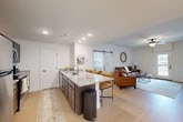 Located at 629 Old Liverpool Rd in Liverpool, NY, this well-appointed 2-bedroom, 2-bathroom single-floor residence offers a thoughtfully designed open-concept layout. The kitchen serves as the heart of the home, boasting dark espresso cabinetry, granite countertops, stainless steel appliances, and a large center island with bar seating — ideal for both cooking and entertaining. Light wood-style flooring flows seamlessly throughout the main living areas, enhancing the bright, airy atmosphere created by recessed lighting and neutral white walls.

The living room is spacious and inviting, featuring a ceiling fan and a glass-paned door that opens to a private balcony with outdoor views. A distinctive sliding barn door adds a modern farmhouse touch, connecting the living area to the primary bedroom. Both bedrooms are generously sized with plush carpeting, ceiling fans, and large windows that allow ample natural light. The expansive primary bedroom includes a walk-in closet with built-in wire shelving for organized storage.

The bathrooms are clean and functional, with one featuring a full tub and shower enclosure with glass sliding doors. A dedicated laundry room with full-size washer and dryer completes this practical and stylish home.