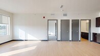 Located at 14965 E Second Ave in Aurora, CO, this one-bedroom, one-bathroom unit offers a well-designed single-floor layout that makes efficient use of its space. The kitchen is a standout feature, outfitted with rich dark-brown cabinetry, white subway tile backsplash, light wood-style flooring, and a full suite of stainless steel appliances including a refrigerator, range, microwave, and dishwasher — providing both style and functionality. The kitchen opens toward the main living area, which continues the light flooring and benefits from natural light streaming through the space. The bedroom is carpeted for comfort and features a ceiling fan, a dedicated closet for storage, and a sliding glass door that opens to a private balcony with open outdoor views. The bathroom is clean and functional, featuring a full tub-shower combination with white subway tile surround, light wood-style flooring, and dark wood vanity cabinetry consistent with the kitchen's design language. Neutral-toned walls and gray base trim are carried throughout, lending the unit a cohesive and contemporary aesthetic well-suited to everyday living.