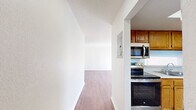 This well-designed apartment in Summit West offers 1060 square feet of comfortable living space across a single floor. The layout includes three bedrooms, with the primary bedroom boasting a generous 180 square feet. Two full bathrooms provide convenience for residents and guests alike.

The heart of the home is a modern kitchen, featuring honey-toned wood cabinetry, stainless steel appliances, and ample counter space. A dedicated laundry room with full-sized washer and dryer adds practicality to daily life.

Throughout the apartment, warm wood-look flooring creates a cohesive and inviting atmosphere. Large windows in the bedrooms and living areas flood the space with natural light, while vertical blinds offer privacy control. The living room is accented by a stylish ceiling fan, enhancing both comfort and aesthetics.

Both bathrooms are thoughtfully appointed, with one featuring a spacious walk-in shower with safety bars. The other bathroom offers a combination of functionality and style with its vanity and storage cabinet.

The apartment's neutral color palette provides a blank canvas for personal decor preferences. With its efficient use of space and modern amenities, this Summit West apartment offers a blend of comfort and convenience in a prime location.
