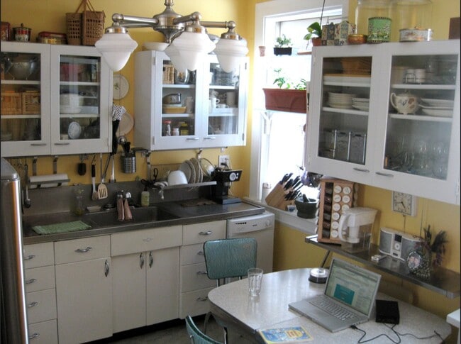 In this photo you can see the kitchen as furnished by a resident. Take advantage of the glass shelves built into each window frame to grow your kitchen herbs! - 3284 Dawson Street