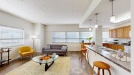 Located at 200 N Harvey Ave in the heart of Oklahoma City, this one-bedroom, one-bathroom residence offers a well-organized single-floor layout with a comfortable and functional design throughout.

The entrance opens into a hallway that connects the main living areas. The open-concept living room is generously proportioned, bathed in natural light from multiple large windows fitted with blinds. Track lighting along the ceiling adds additional illumination, and wood-style plank flooring runs throughout, contributing to a warm, cohesive aesthetic.

The kitchen features warm-toned wood cabinetry, dark granite-style countertops, white appliances, and tile flooring. A peninsula with seating extends into the living area, creating a convenient breakfast bar that enhances the open flow between the kitchen and living spaces. Pendant lighting above the bar adds a polished finishing touch.

The bedroom is a well-sized private retreat with a ceiling fan, large windows that invite natural light, and direct access to a walk-in closet with built-in shelving. A second closet provides additional storage elsewhere in the unit.

The bathroom includes a vanity with wood cabinetry, dark countertops, and a large mirror. Throughout the residence, the clean white walls and consistent flooring create a bright, unified atmosphere suited for comfortable urban living.