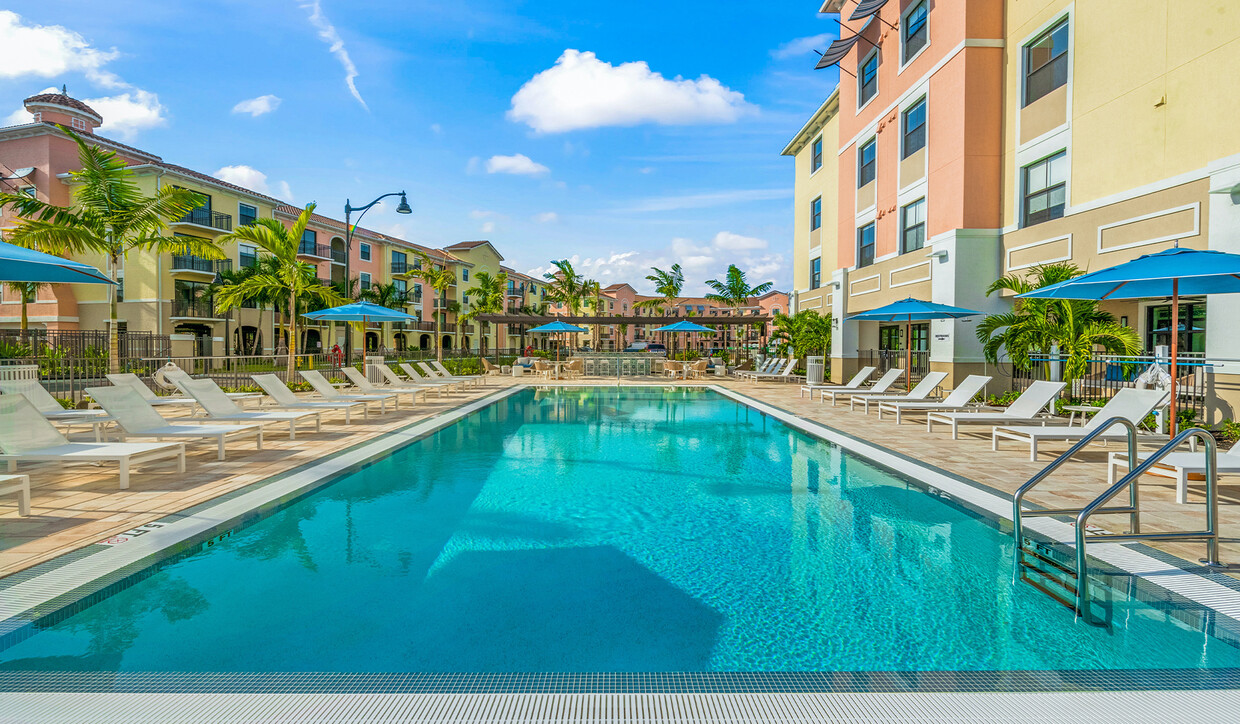 Unwind and relax at your spacious community pool. - The Reserve at Coconut Point