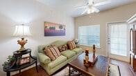 Located in Fort Worth, TX, this two-bedroom, two-bathroom residence offers a practical and comfortable single-floor layout. The living room is bright and welcoming, featuring wood-style flooring, a ceiling fan, and a large window that fills the space with natural light. Adjacent to the living area, the dedicated dining space provides an intimate setting, accented by neutral walls and a decorative mirror. The kitchen is well-appointed with warm oak cabinetry, granite-style countertops, black appliances, a double stainless steel sink, and a skylight overhead that adds an airy feel. The primary bedroom is a spacious retreat with a ceiling fan and ample room for full-size furnishings. The second bedroom offers versatile space suitable for guests or a children's room. Both bathrooms are finished with oak vanities, granite-style countertops, and wood-style flooring, maintaining a consistent aesthetic throughout. A dedicated laundry room houses a full-size washer and dryer with overhead shelving for additional storage. Two closets and two hallways further enhance the functional flow of this well-organized residence.