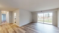 Located at 12 Oaktree Ln in Williamsport, Maryland, this single-floor residence presents a clean, modern aesthetic enhanced by updated finishes throughout. Luxury vinyl plank flooring in warm wood tones flows continuously across every room, lending a cohesive and polished look to the entire space.

The living area is bright and open, with a sliding glass door leading to a private balcony that offers pleasant views of the surrounding greenery. Natural light fills the room, creating an inviting atmosphere well-suited for both relaxing and entertaining.

The galley-style kitchen is well-appointed with white shaker cabinetry, granite-style countertops, a classic white subway tile backsplash, and a full suite of stainless steel appliances including a refrigerator, electric range, over-the-range microwave, and dishwasher.

The bedrooms are comfortably sized, each benefiting from large windows with peaceful outdoor views. Ample closet space is provided, including a walk-in closet in one of the bedrooms. The bathrooms feature a crisp, updated design with marble-style tile surrounding the bathtub and shower, white vanity cabinetry, and brushed nickel fixtures. The entry foyer provides a welcoming transition into the home. Overall, the space combines functional design with contemporary finishes for a fresh, move-in-ready feel.