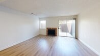 Located in Madera, CA, this two-story, 2-bedroom, 4-bathroom home is thoughtfully laid out across two floors. The main level features an open living room and kitchen area with a seamless flow between spaces. Light wood-style flooring runs through the living room, which is highlighted by a classic tiled fireplace and a ceiling fan overhead. A sliding glass door opens to the outdoor patio area, bringing in natural light and providing outdoor access. The kitchen is well-equipped with warm wood cabinetry, granite-style countertops, tile flooring, and white appliances including a range and refrigerator, with a pass-through window connecting to the living area. The bathrooms are cleanly finished with wood vanities, granite countertops, framed mirrors, and light hardwood-style flooring, with at least one featuring a soaking tub. Upstairs, both bedrooms are carpeted with textured ceilings and windows that offer exterior views, keeping the rooms bright and comfortable. The spacious primary bedroom provides a functional retreat, while the second bedroom offers similar comfort. A dedicated closet and hallway complete the upper level, making this a practical and well-organized home.