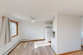 This one-bedroom, one-bathroom unit in Red Deer, Alberta offers a practical and well-organized layout across a single floor. The living room is carpeted and bathed in natural light through a large window with outdoor views, creating a bright and comfortable space for relaxing. Adjacent to the living area, the dining room features wood-look laminate flooring, a ceiling fan with light fixture, and a window that continues to bring in natural light.

The kitchen is well-appointed with white shaker-style cabinetry extending to the ceiling for generous storage, light stone-pattern countertops, a double stainless steel sink, and white appliances including a refrigerator and electric range. A convenient pass-through connects the kitchen to the dining area.

The bedroom is a comfortable size, featuring plush carpet, a sliding wood-panel closet, a window with outdoor views, and a baseboard heating unit. Four closets throughout the unit provide exceptional storage capacity.

The bathroom is clean and functional, featuring a full tiled tub-surround, a white vanity, and wood-look vinyl flooring. A private patio adds outdoor access. Baseboard heating is present throughout, ensuring year-round comfort in this efficiently designed Red Deer residence.