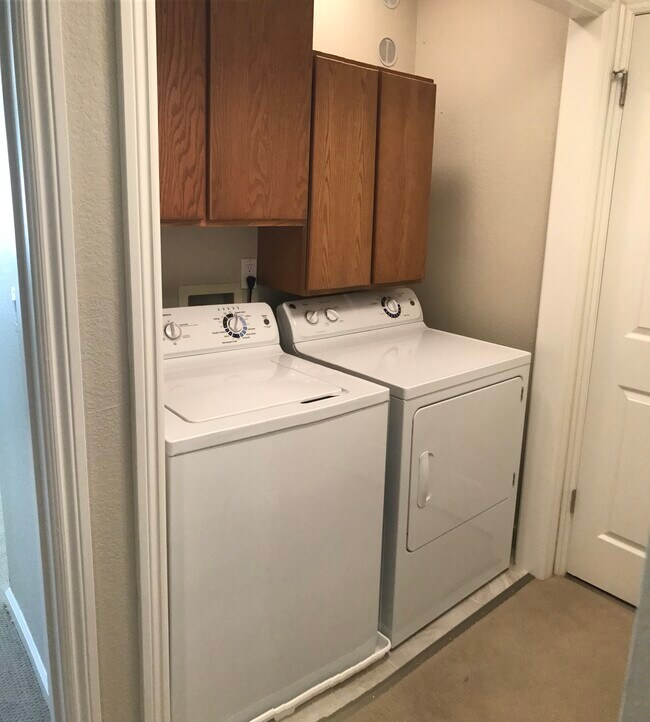 Washer and dryer with utility cabinets. - 203 Bean Creek Road
