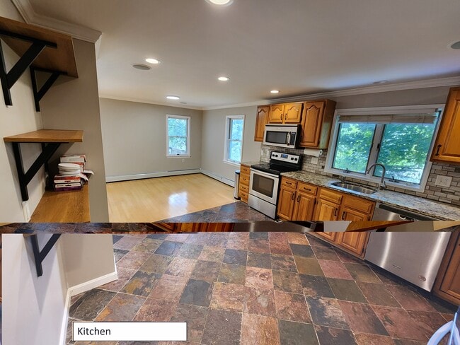 Kitchen w/ slate floor and stainless appliances. Opens into dining room. - 68 Peach Orchard Rd