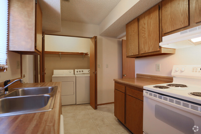 Kitchens are equipped with all major appliances, and washer/dryer are conveniently nearby. - Ravenwood Townhomes