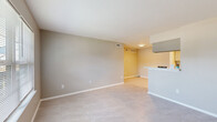 Located at 2909 Hayes Rd in Houston, TX, this three-bedroom, one-bathroom single-story home offers a practical and well-organized layout. Light neutral tones and large-format tile flooring run consistently throughout, creating a cohesive and easy-to-maintain interior.

The open-concept living area is bright and welcoming, featuring a front-facing window that draws in natural light and a textured ceiling. The space flows directly into the kitchen, which is equipped with sage-green shaker-style cabinetry, stainless steel appliances including a refrigerator and dishwasher, a black electric range, a peninsula with a light-colored countertop, and a skylight-style ceiling fixture that illuminates the galley-style workspace.

The primary bedroom is generously proportioned, featuring a ceiling fan with light fixture, a walk-in closet, and a window with outdoor views. The two additional bedrooms also offer closet storage, ceiling fans, and tile flooring, making each room functional and comfortable.

The bathroom is clean and efficiently laid out, featuring a tub-shower combination with white tile surround, a toilet, a vanity with a marble-style countertop, and coordinating brushed nickel fixtures. A dedicated closet provides additional storage within the home.