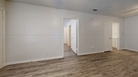 This efficiently designed 490 square foot apartment in Killeen, Texas, maximizes space and functionality. The single-story layout comprises one bedroom, one bathroom, a living room, kitchen, and closet. The primary bedroom, measuring 120 square feet, offers ample space for rest and relaxation.

Throughout the apartment, modern wood-look flooring adds warmth and durability. The rooms feature a neutral color palette with white walls, creating a bright and airy atmosphere. Large windows with horizontal blinds allow for abundant natural light and privacy control.

The living area showcases a unique design element with white paneling on the lower half of the walls, adding visual interest and texture. The kitchen, while compact, is well-equipped with white cabinetry, a sink, and essential appliances. A small area rug adds a touch of comfort to the space.

The bathroom, though modest in size, includes a bathtub-shower combination, toilet, and storage shelves for convenience. The bedroom features a ceiling fan for improved air circulation and comfort.

Storage solutions are integrated throughout, including a dedicated closet space. The apartment's layout promotes an open-concept feel, making the space appear larger and more inviting. Located at 2908 Lake Rd, this apartment offers a comfortable living environment in a convenient Killeen location.