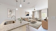 This contemporary 610 square foot apartment in Tapestry Long Farm offers a harmonious blend of style and functionality. The open-concept design maximizes the use of space, featuring a combined kitchen and living area that creates a seamless flow for modern living.

The kitchen stands out with its crisp white cabinetry, stainless steel appliances, and granite countertops. A convenient breakfast bar with stylish stools provides additional seating and dining space. The living area is bathed in natural light from large windows, complemented by sheer curtains that offer privacy without sacrificing brightness.

The bedroom, measuring 130 square feet, is a serene retreat with ample space for a queen-sized bed and additional furniture. It features a large window, ceiling fan, and neutral tones that create a calming atmosphere. The bathroom continues the modern aesthetic with clean lines and contemporary fixtures.

A notable feature is the in-unit laundry area, enhancing the convenience of this compact home. Throughout the apartment, wood-look flooring adds warmth and durability. The overall design aesthetic is clean and minimalist, with a neutral color palette accented by subtle artistic elements that add character to the space.

Storage solutions are integrated throughout, including closets and kitchen cabinetry, maximizing the utility of the compact floor plan. This well-designed apartment offers a perfect balance of comfort and style for urban living.