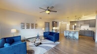 Located at 3281 Tutt Blvd in Colorado Springs, Colorado, this single-story unit offers a thoughtfully designed open-concept layout with contemporary finishes throughout. The living area serves as the centerpiece of the space, featuring wood-style plank flooring, a ceiling fan, and a striking built-in electric fireplace set into an accent wall. Natural light filters through windows dressed with sheer curtains, creating a bright and welcoming atmosphere.

The kitchen is well-appointed with gray shaker-style cabinetry, white quartz countertops, stainless steel appliances, and a breakfast bar with pendant lighting — ideal for both cooking and casual dining. The open sightlines between the kitchen and living area reinforce the spacious, connected feel of the layout.

The primary bedroom features plush carpeting, a ceiling fan, and a generous walk-in closet outfitted with multi-level wire shelving. Its en-suite bathroom includes a dual-sink vanity with gray cabinetry, quartz countertops, and wood-style flooring. A second bedroom also offers comfortable carpeting and ample natural light, served by a second full bathroom with a tub-shower combination and matching gray vanity finishes consistent with the overall design aesthetic.