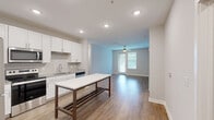 Located at 10118 Meads Dr in Mauldin, SC, this single-story home offers four bedrooms and two bathrooms within a thoughtfully designed floor plan. The open-concept kitchen and living area serves as the heart of the home, featuring white shaker cabinetry, granite countertops, a subway tile backsplash, stainless steel appliances including a range, microwave, dishwasher, and refrigerator, and a central island with a white surface — ideal for meal prep or casual dining. Recessed lighting and a ceiling fan enhance the space, which flows seamlessly into the living room, where a ceiling fan and a glass door invite natural light and outdoor access.

The bedrooms are generously proportioned, with the primary bedroom offering ample space for a full suite setup. Bedrooms feature hardwood-style flooring, ceiling fans, and large windows with blinds that allow natural light to fill each room. Several bedrooms include closets with built-in shelving or hanging rods. Neutral-toned walls throughout create a clean, versatile aesthetic.

The bathrooms are finished with clean, modern fixtures, including a glass-enclosed walk-in shower with built-in shelving and grab bars for added accessibility. A dedicated laundry room houses a full-size Whirlpool washer and dryer with overhead wire shelving for additional storage. Consistent hardwood-style flooring runs throughout the entire home, tying the spaces together cohesively.