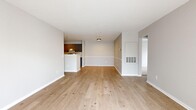 Located at 100 Avalon Haven Dr in North Haven, CT, this well-appointed 3-bedroom, 2-bathroom single-floor residence offers a thoughtfully designed layout across a comfortable footprint. The open living and dining area is anchored by light-toned hardwood flooring and neutral gray walls, creating a bright and airy atmosphere. A pass-through peninsula connects the living area to the galley-style kitchen, which features gray shaker cabinets with gold hardware accents, white quartz countertops, a subway tile backsplash, and a full suite of stainless steel appliances including a gas range, dishwasher, and refrigerator. Both bathrooms are finished with white tiled tub-shower combinations and elegant gold fixtures, complemented by clean white vanities. The bedrooms are carpeted for comfort, with the primary bedroom boasting a distinctive bay window configuration that floods the room with natural light and offers views of the surrounding landscape. Secondary bedrooms also feature generous windows. Three hallways provide smooth circulation throughout the home. The consistent use of gold hardware and neutral tones throughout ties the design together, giving the residence a cohesive and modern aesthetic.