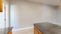 Located at 2014 Park St in Hartford, CT, this efficient one-bedroom, one-bathroom unit offers a well-designed layout that maximizes every square foot of its compact footprint. Light hardwood flooring runs throughout, complementing the neutral, warm-toned walls that lend the space a clean and cohesive aesthetic.

The kitchen is a standout feature, equipped with warm wood cabinetry, rich dark granite countertops, and a full suite of stainless steel appliances including a gas range, over-the-range microwave, and refrigerator. A peninsula provides additional counter space and casual dining potential. Natural light filters in through a window, brightening the cooking area.

The bedroom is a comfortable, well-proportioned room featuring light-filled windows with blinds, light hardwood floors, and a wall-mounted PTAC heating and cooling unit for year-round climate control. Two interior doors lead to closet and hallway access, adding practical storage and flow to the room.

The bathroom is neatly appointed with a white vanity, mirrored medicine cabinet, tiled tub-shower combination with a glass enclosure, and tile flooring — all finished in a clean, bright palette.

Overall, this unit offers a functional and updated living space suited for those seeking a well-maintained home in Hartford.