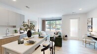 Located at 1031 N Vermont St in Arlington, VA, this thoughtfully designed one-bedroom, one-bathroom residence offers a modern open-concept layout on a single floor. Light wood flooring flows throughout, complementing the bright, white walls and creating a clean, cohesive aesthetic.

The open living and dining area is anchored by a large picture window that frames lush greenery views and fills the space with natural light. A frosted-glass entry door adds privacy while maintaining an airy feel. The well-appointed kitchen features two-tone cabinetry — warm wood lower cabinets paired with soft gray uppers — white quartz countertops, a subway tile backsplash, stainless steel appliances, and a peninsula with bar seating, ideal for casual dining.

The bedroom offers a comfortable retreat with a sizable window overlooking outdoor greenery, light wood flooring, and a dedicated closet. The full bathroom includes light wood vanity cabinetry, a large mirror, tile flooring, and a shower-tub combination. An in-unit laundry area adds everyday convenience. A hallway connects the private spaces efficiently. The overall ambiance is contemporary and welcoming, with a neutral palette and modern finishes throughout.
