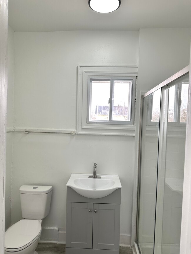 Baño moderno con puertas de ducha corredizas de vidrio. - 249 Central Park
