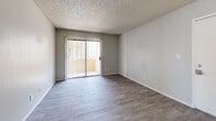 Located at 4748 W Sierra Vista Dr in Glendale, Arizona, this one-bedroom, two-bathroom residence offers a thoughtfully arranged single-level layout. The updated kitchen is a standout feature, showcasing white cabinetry, light granite-style countertops, a subway tile backsplash, and stainless steel appliances including a range and refrigerator. A peninsula with a built-in sink connects the kitchen to the living area, creating an open, functional flow. Light wood-style flooring runs throughout the main living spaces, complementing the neutral gray walls and textured ceilings.

The living room is comfortably sized with sliding glass doors that open to an outdoor area, allowing natural light to fill the space. The bedroom is carpeted and features two windows that bring in additional natural light and outdoor views, along with double doors leading to the hallway and closet. Both bathrooms are clean and modern, with one featuring a full soaking tub and tiled surround. A hallway bathroom includes a vanity with updated cabinetry and a window, and notably accommodates a stacked washer and dryer unit, adding everyday convenience to this well-appointed Glendale residence.