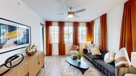 Located at 2085 S Congress Ave in Palm Springs, FL, this thoughtfully designed single-floor residence offers three bedrooms and two full bathrooms within a efficiently utilized floor plan. Light wood-tone flooring flows seamlessly throughout, creating a cohesive and warm aesthetic across all rooms.

The living room is bathed in natural light from multiple windows dressed with rich terracotta-hued curtains and white blinds, complemented by a ceiling fan overhead. The bright, open atmosphere makes it an inviting space for relaxing or entertaining.

The kitchen features a contemporary two-tone design with white upper cabinetry and warm wood-finish lower cabinets, white quartz countertops, a subway tile backsplash, and stainless steel appliances including a range, microwave, and dishwasher.

The primary bedroom is generously sized, offering a ceiling fan, natural light, and a well-organized walk-in closet with full-length hanging storage. The en-suite bathroom includes a glass-enclosed walk-in shower, wood-finish vanity, and white countertops.

The second bathroom features a soaking tub with a tiled shower surround, a wood-finish vanity, and clean white finishes. Hallways connect the rooms efficiently, and recessed lighting ensures a bright, modern ambiance throughout this well-designed Palm Springs home.