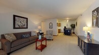 Located on White Oak Circle in Menomonee Falls, Wisconsin, this single-floor residence features a thoughtfully designed open layout that connects its primary living areas with ease. The spacious living room is carpeted and anchored by a large sliding glass door fitted with vertical blinds, allowing natural light to fill the space. The open flow guides seamlessly toward a dining area and into the kitchen, which features warm oak cabinetry, tile flooring, a double sink, and white appliances including a refrigerator and dishwasher — providing a practical and efficient workspace.

The primary bedroom is generously sized with plush carpeting, a natural window, and ample room for furniture arrangement. A second room, currently configured as a home office, offers flexible use with carpeted floors and a window. The full bathroom includes a warm oak vanity with a wide countertop, tile flooring, and a tub-shower combination. Throughout the residence, consistent neutral tones, carpet in living areas, and wood-toned trim create a cohesive and comfortable atmosphere well-suited to everyday living.