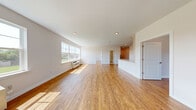 Located at 35 Spring St, Unit 307 in Wallington, NJ, this well-appointed one-bedroom, one-bathroom residence offers a thoughtfully designed layout across a single floor. Warm hardwood flooring flows throughout the entire unit, complementing the clean, neutral palette of white walls and recessed lighting.

The open-concept living and dining area is generously proportioned, bathed in natural light through large double-pane windows that frame outdoor greenery views. The kitchen is a standout feature, showcasing tall white shaker-style cabinetry extending to the ceiling for abundant storage, a white quartz peninsula countertop, and a full suite of stainless steel appliances including a gas range, microwave, dishwasher, and refrigerator. A pantry provides additional storage convenience.

The bedroom is a comfortable, sunlit retreat with large windows overlooking green outdoor scenery, a dedicated closet, and a walk-in closet with built-in shelving. The bathroom features an elegant tub-shower combination with marble-style wall surround panels and brushed nickel hardware. Additional highlights include in-unit laundry, a dedicated entrance, and three closets total throughout the unit, ensuring ample storage at every turn.
