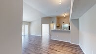 Located at 1010 NW Fresco Way in Stuart, FL, this single-story, 3-bedroom, 1-bathroom home offers a well-designed open-concept layout with consistent wood-style flooring throughout. The combined kitchen and living area serves as the heart of the home, featuring vaulted ceilings that enhance the sense of space and openness. The kitchen is equipped with stainless steel appliances — including a refrigerator, range, and over-the-range microwave — light wood cabinetry, a stainless steel sink, and a peninsula counter that provides additional prep space and a natural division between the kitchen and living areas. The living room benefits from a sliding glass door that floods the space with natural light and provides access to an outdoor balcony area with exterior views. Each of the three bedrooms offers wood-style flooring, neutral wall tones, and generous natural light. The spacious primary bedroom includes a sliding door closet. The bathroom features a full tub-shower combo, a wide vanity mirror, light wood cabinetry, a white countertop, and wood-style flooring. A hallway with a dedicated closet completes the layout. The home's neutral color palette and clean finishes create a bright, functional living environment.